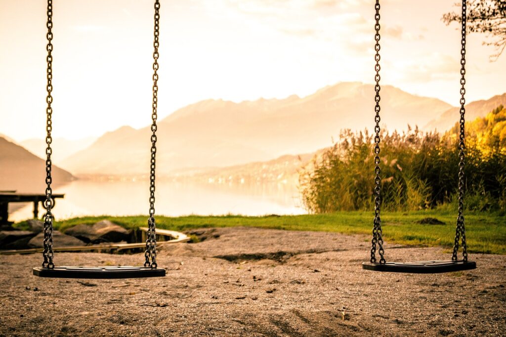 empty swings on a beach 